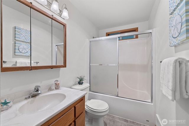 5675 Winona Ln, Langley, WA 98260 - bathroom featuring bath / shower combo with glass door, vanity, and toilet
