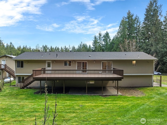 5675 Winona Ln, Langley, WA 98260 - back of house featuring a lawn, stairway, and a deck
