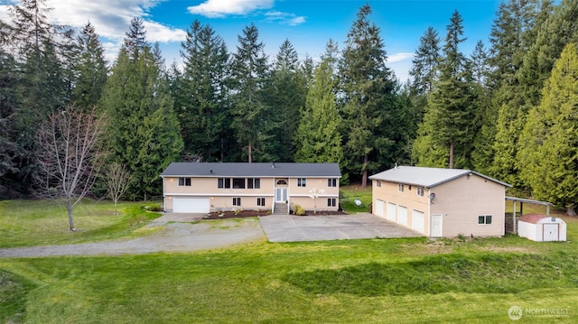 5675 Winona Ln, Langley, WA 98260 - split foyer home featuring driveway, an outbuilding, a storage unit, a front yard, and a garage