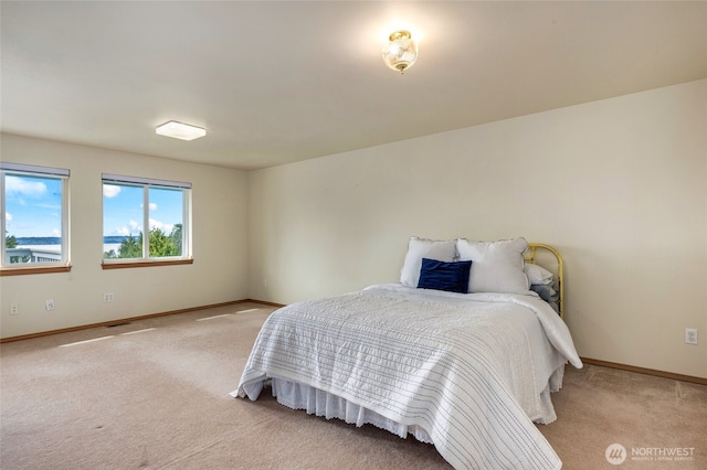 carpeted bedroom featuring baseboards