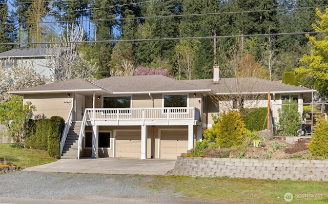 19529 Locust Way, Lynnwood, WA 98036 - view of front of home with stairs, stucco siding, driveway, an attached garage, and a chimney
