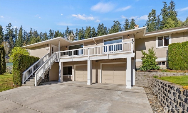 19529 Locust Way, Lynnwood, WA 98036 - view of front of house featuring an attached garage, a chimney, driveway, stucco siding, and stairway