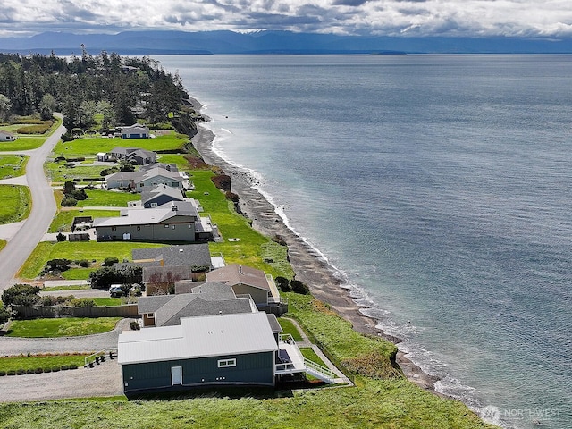 birds eye view of property featuring a beach view and a water view