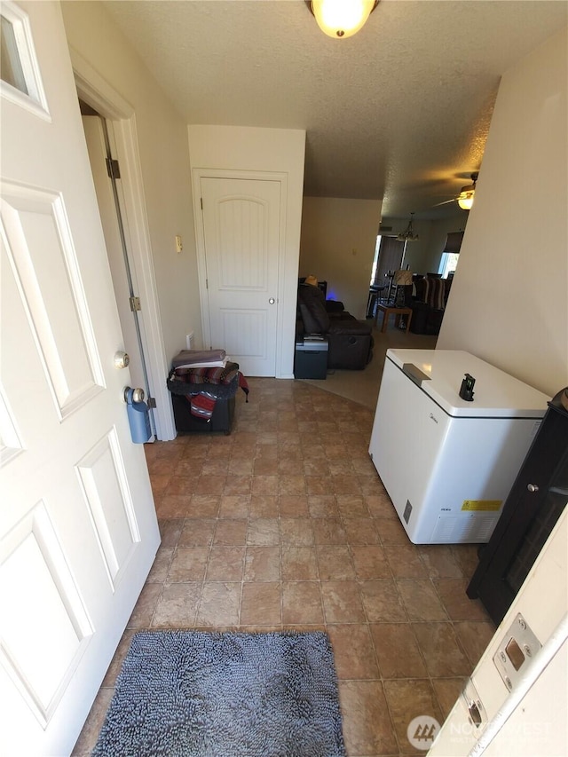 washroom featuring a ceiling fan and stone finish floor