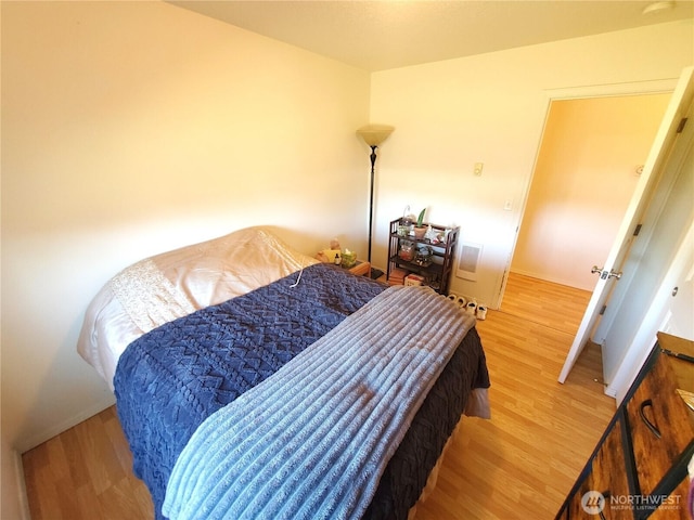 bedroom featuring baseboards and wood finished floors