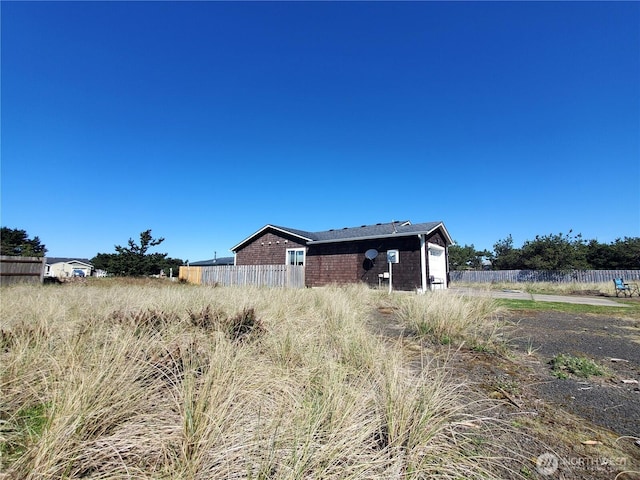 view of side of property featuring fence