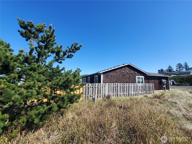 view of side of property with fence
