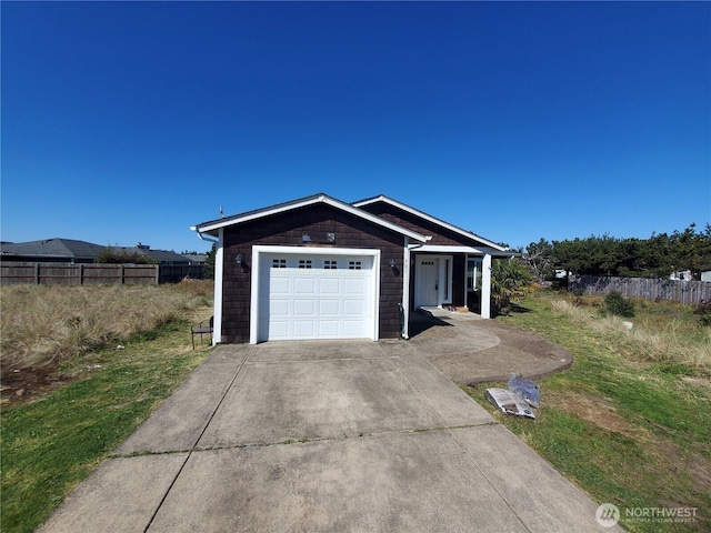 ranch-style house with a garage, concrete driveway, and fence