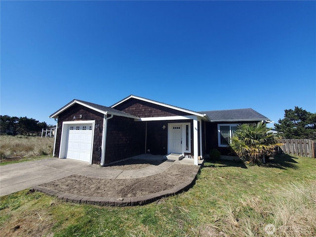 ranch-style house featuring fence, an attached garage, a front lawn, and concrete driveway