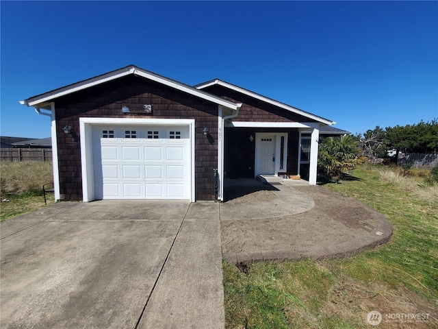 ranch-style home with concrete driveway and a garage