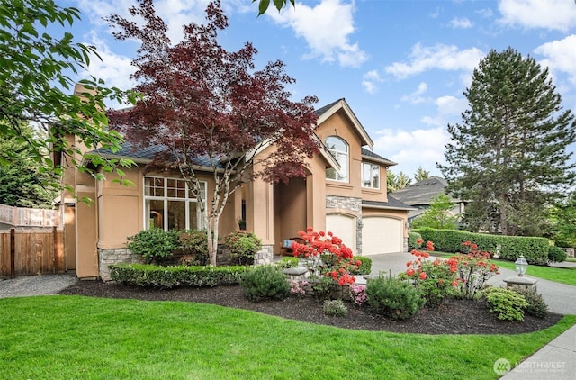 view of front of property with stone siding, stucco siding, an attached garage, and concrete driveway