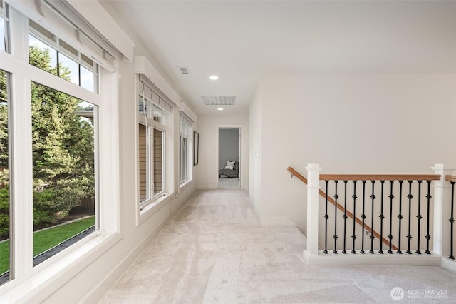 corridor featuring an upstairs landing, carpet flooring, recessed lighting, and baseboards