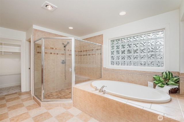 bathroom featuring a shower stall, a garden tub, a spacious closet, recessed lighting, and tile patterned flooring