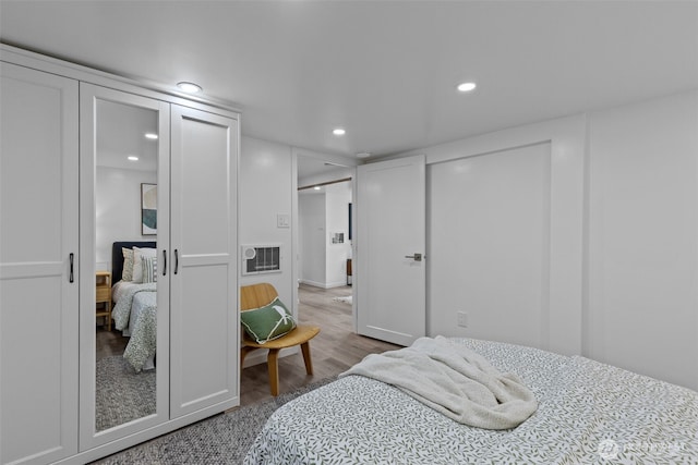 bedroom with recessed lighting and wood finished floors