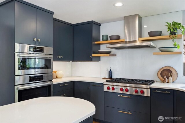 kitchen featuring light countertops, open shelves, appliances with stainless steel finishes, and island range hood