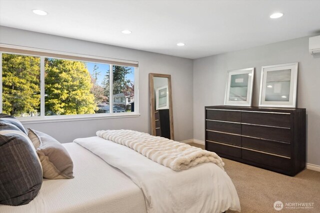 carpeted bedroom featuring recessed lighting, baseboards, and a wall mounted air conditioner