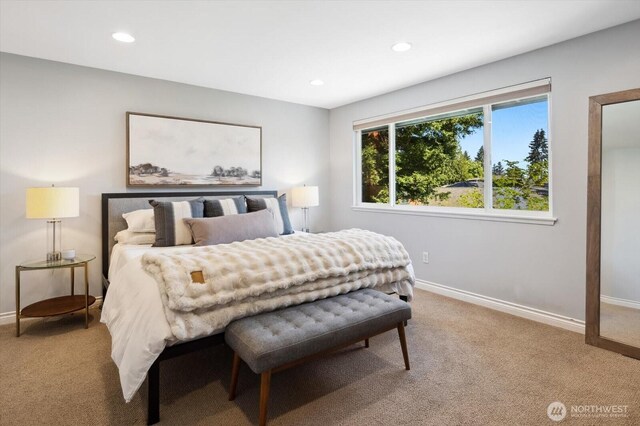 bedroom featuring light colored carpet, recessed lighting, and baseboards