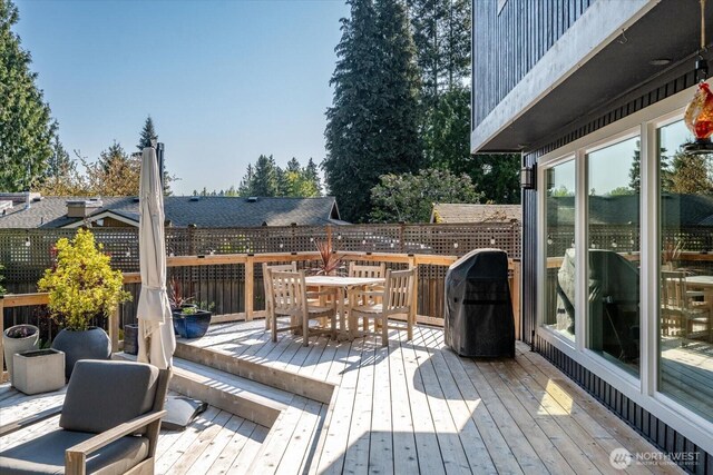 wooden terrace with outdoor dining area