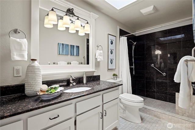 bathroom featuring visible vents, tile patterned flooring, a tile shower, vanity, and toilet