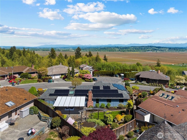 drone / aerial view featuring a residential view and a mountain view