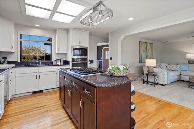 kitchen featuring white cabinetry, open floor plan, appliances with stainless steel finishes, and recessed lighting