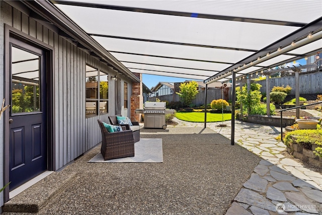 view of patio featuring fence, a pergola, and grilling area