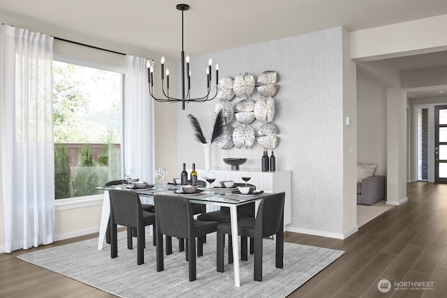 dining space with wallpapered walls, wood finished floors, baseboards, and an inviting chandelier