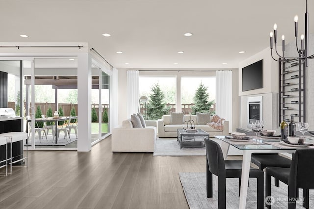 dining space with recessed lighting, an inviting chandelier, and wood finished floors