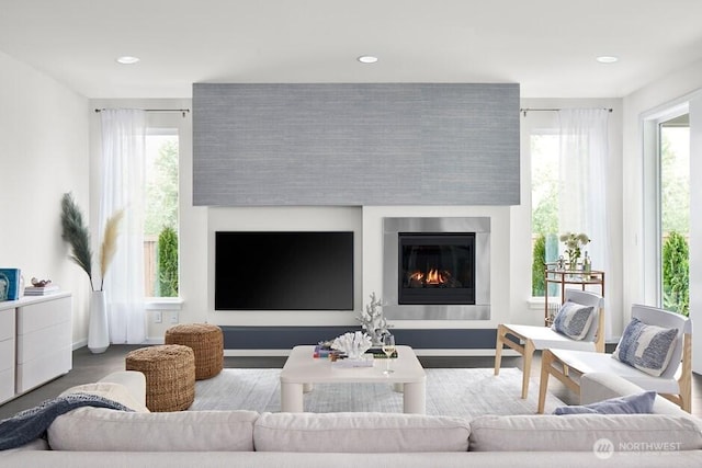 living room featuring baseboards, recessed lighting, and a fireplace