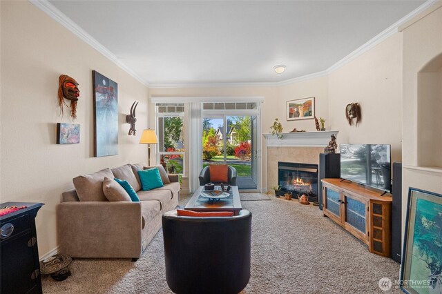 carpeted living area with crown molding, baseboards, and a tile fireplace