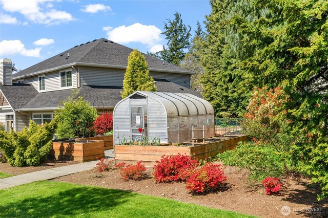 exterior space featuring an outdoor structure, an exterior structure, and a vegetable garden