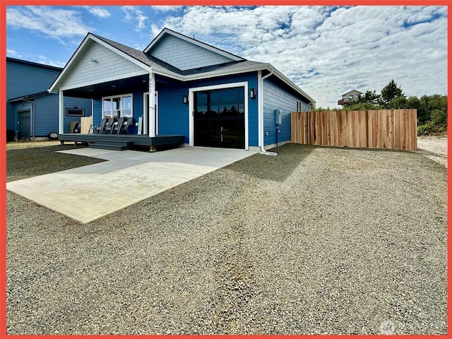 923 Ocean Shores Blvd SW, Ocean Shores, WA 98569 - view of front facade featuring driveway, a garage, and covered porch