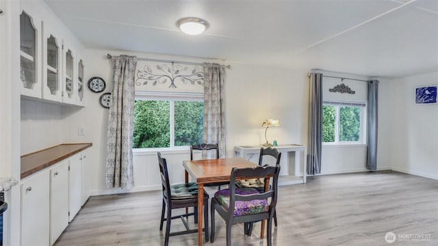 dining space with light wood-style floors and baseboards