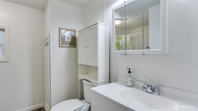 bathroom featuring toilet and vanity