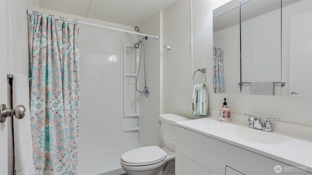 bathroom with a shower stall, toilet, and vanity