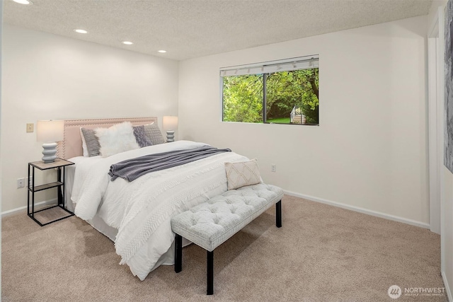 bedroom featuring light carpet, a textured ceiling, recessed lighting, and baseboards