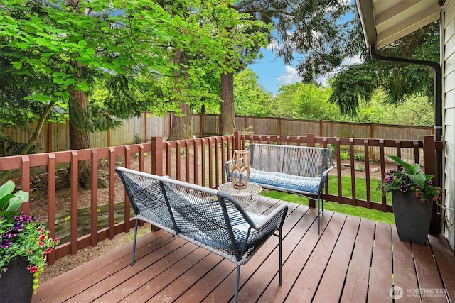 wooden terrace featuring a fenced backyard