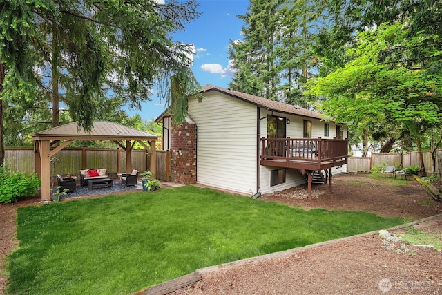 back of house with outdoor lounge area, a gazebo, a wooden deck, and a patio area