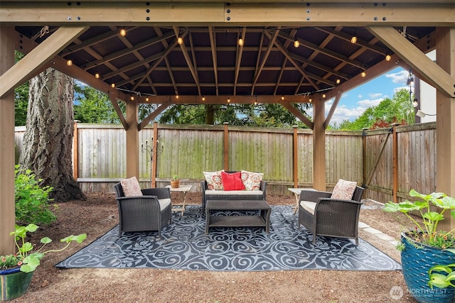 view of patio / terrace with a gazebo, outdoor lounge area, and a fenced backyard