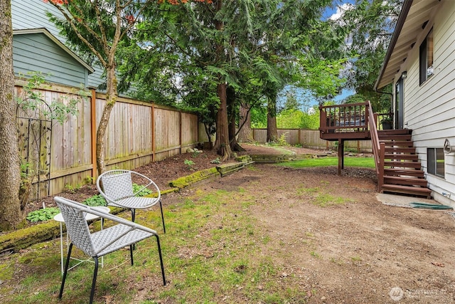 fenced backyard with stairway and a wooden deck
