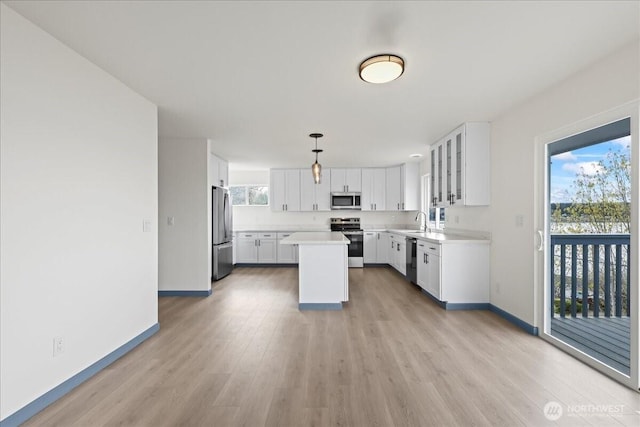 9360 SE Southworth Dr, Port Orchard, WA 98366 - kitchen with light wood-style floors, a sink, baseboards, and stainless steel appliances