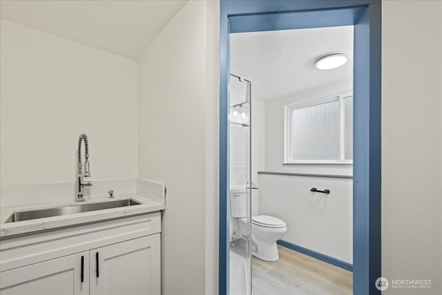 9360 SE Southworth Dr, Port Orchard, WA 98366 - bathroom with toilet, vanity, wood finished floors, and walk in shower