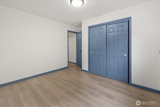 9360 SE Southworth Dr, Port Orchard, WA 98366 - unfurnished bedroom featuring a closet, baseboards, and light wood finished floors