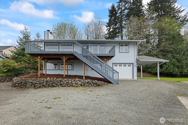 9360 SE Southworth Dr, Port Orchard, WA 98366 - view of front of house featuring stairway, gravel driveway, an attached garage, a chimney, and a deck