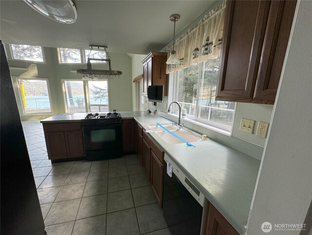 218 Pass View Rd, Decatur Island, WA 98221 - kitchen with black appliances, a sink, a peninsula, light countertops, and light tile patterned floors