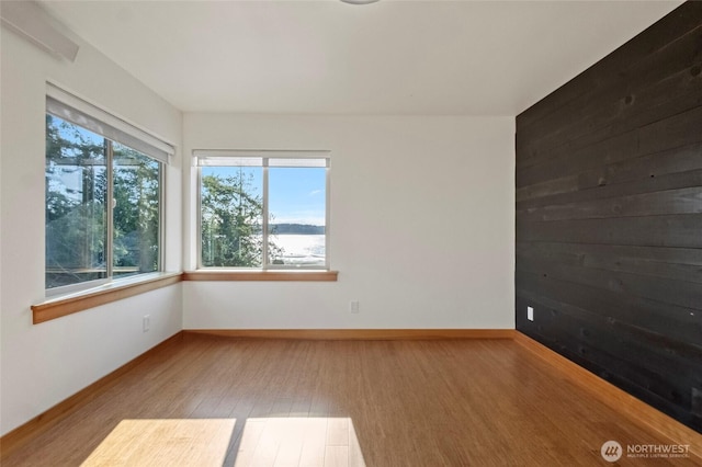 8996 Dearborn Ave, Blaine, WA 98230 - spare room with baseboards, a water view, and wood finished floors