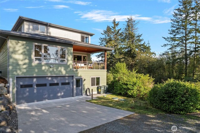 8996 Dearborn Ave, Blaine, WA 98230 - view of front of house with an attached garage, driveway, and a balcony