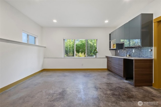 8996 Dearborn Ave, Blaine, WA 98230 - kitchen featuring baseboards, light countertops, backsplash, and a healthy amount of sunlight
