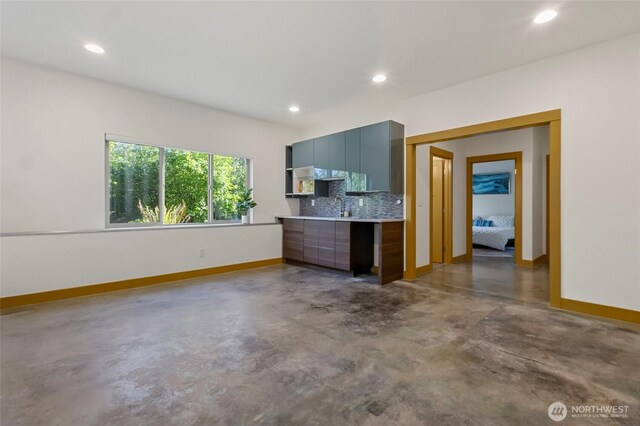 8996 Dearborn Ave, Blaine, WA 98230 - unfurnished living room with a sink, baseboards, concrete flooring, and recessed lighting