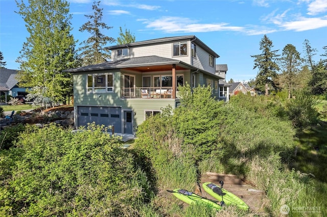 8996 Dearborn Ave, Blaine, WA 98230 - rear view of house with an attached garage and a balcony
